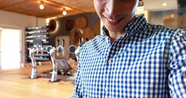 Smiling Man in Plaid Shirt at Modern Brewery Tasting Room - Download Free Stock Images Pikwizard.com