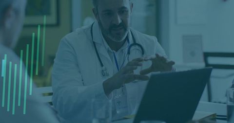 Doctor explaining health information using laptop in clinic