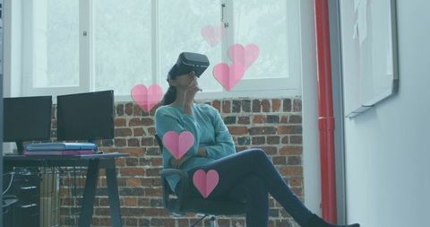 Woman Wearing VR Headset in Modern Office With Virtual Heart Icons