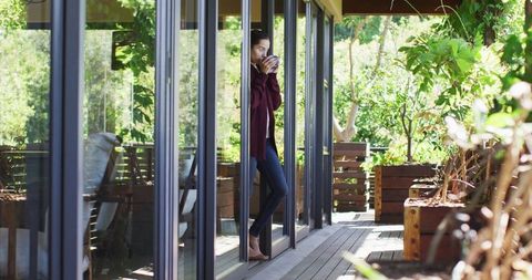 Relaxed Woman Sipping Coffee on Sunlit Patio, Embracing Morning Calm - Download Free Stock Images Pikwizard.com