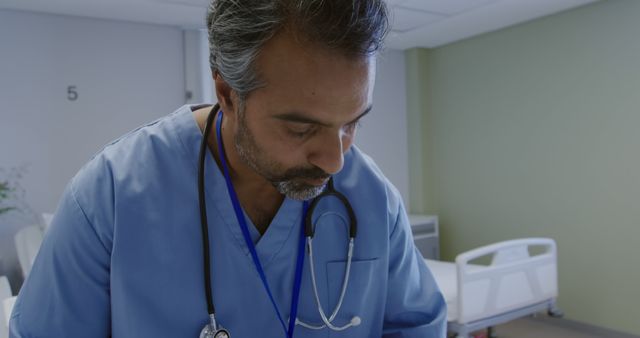 Male Doctor Focused On Patient Care In Hospital Room - Download Free Stock Images Pikwizard.com