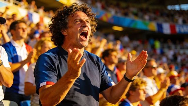 Passionate ecstatic fan shouting and clapping in packed stadium during sunny soccer match