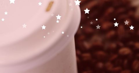 Festive Coffee Cup with Falling Stars Background