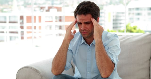 Man Holding Temples Suffering from Headache at Home - Download Free Stock Images Pikwizard.com