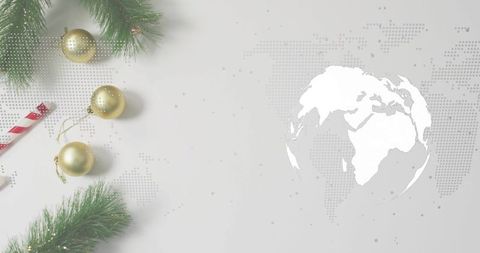 Minimal Holiday Flatlay with Gold Baubles, Candy Cane and World Map Globe