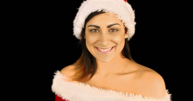 Female Smiling in Santa Hat and Christmas Costume on Black Background - Download Free Stock Images Pikwizard.com