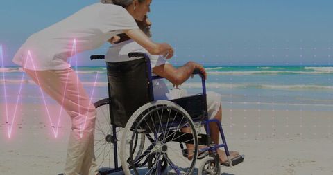 Senior Couple with Wheelchair on Beach: Health and Care Concept