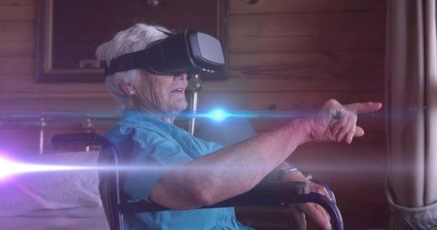 Senior woman in wheelchair immersed in virtual reality experience
