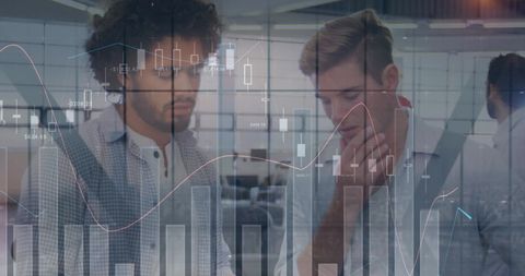 Diverse Colleagues Analyzing Financial Trends in Modern Office