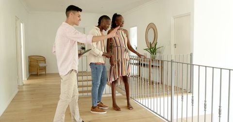 Couple Touring Home with Realtor Having Casual Conversation