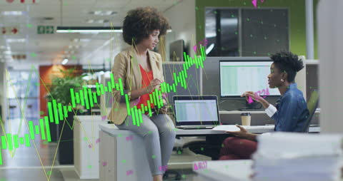 Diverse Female Team Collaborating with Financial Graphs Overlay