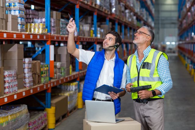 Warehouse workers interacting with each other in warehouse