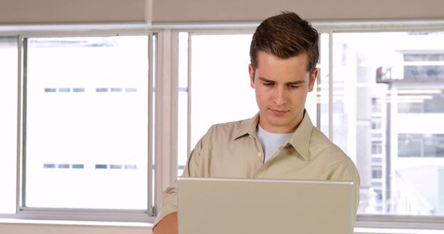 Focused Male Professional Typing on Laptop in Modern Office - Download Free Stock Images Pikwizard.com