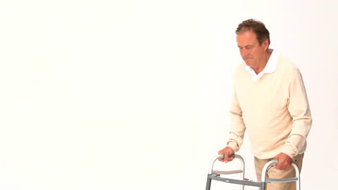 Elderly Man Using Walker for Support During Therapy