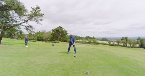 Senior Couple Playing Golf at Scenic Course