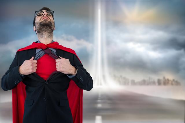 A businessman wearing glasses in a suit tearing open his shirt to reveal a red superhero costume beneath while standing against a cloudy sky. This image can be used for themes related to leadership, self-empowerment, innovation, confidence, success, and professional growth. Ideal for marketing materials, inspirational posters, business presentations, and advertisements.