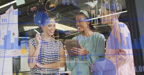 Businesswomen Analyzing Data with Modern Digital Tools in Office