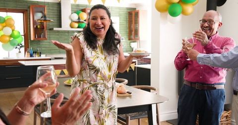 Joyful senior birthday celebration with diverse friends