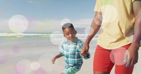 Joyful African American Father and Child on Sunny Beach Walk - Download Free Stock Images Pikwizard.com