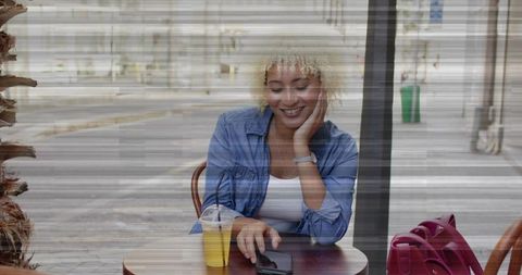 Woman Enjoying Leisure Time at Sidewalk Cafe