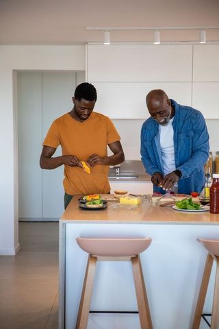 Father and Son Cooking Together, Prepping Vegetables and Cheese at Home
