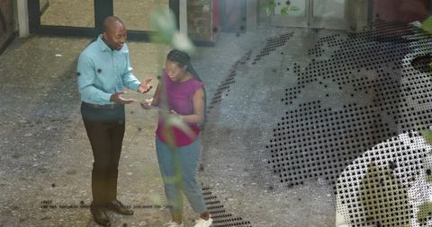 Colleagues collaborating over tablet in modern atrium lobby with halftone overlay