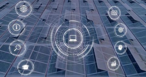 Futuristic digital hud overlay displaying laptop icon over glass skyscraper facade