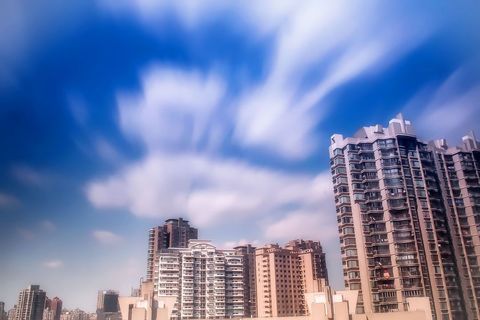 Modern high-rise condo buildings against vibrant sky