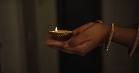 Holding Lit Diya During Diwali Festival Celebration