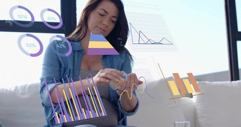 Pregnant woman in denim handling supplement bottle with augmented reality health charts