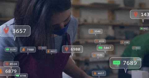 Masked Woman Working at Workshop Bench with Digital Notifications and Metrics Overlays