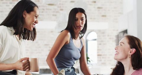 Joyful Friends Celebrating Engagement with Tea and Laughter