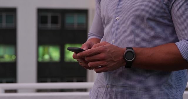 Businessman using smartphone on office balcony - Download Free Stock Images Pikwizard.com