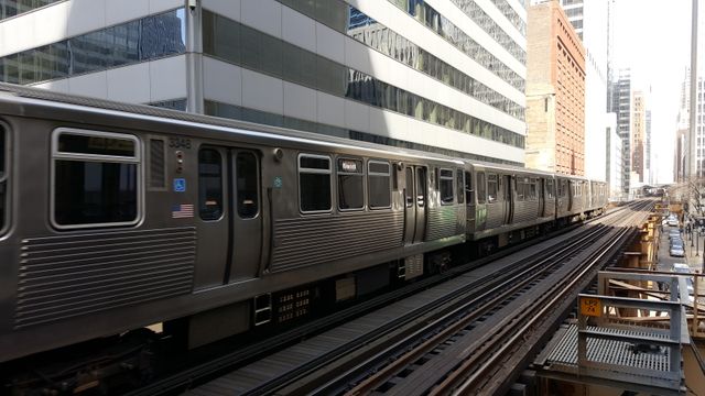 This image showcases an elevated train traveling through a bustling urban environment, surrounded by tall buildings. The scene is ideal for portraying urban living, public transportation systems, or city-related themes. Useful for articles on public transportation, city planning, and modern commuting.