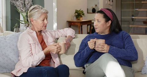 Senior Women Engaging in Warm Conversation at Home