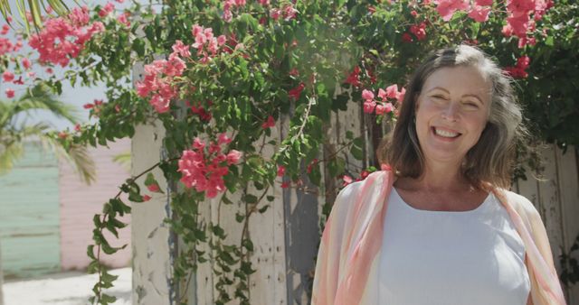 Senior Woman Smiling by Flowering Bush in Garden - Download Free Stock Images Pikwizard.com