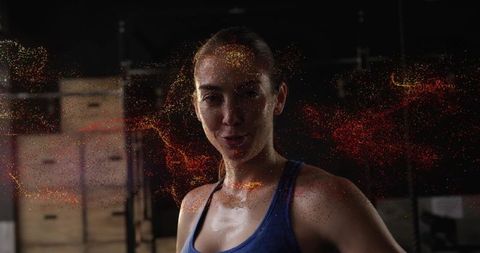 Fitness Woman in Gym Amid Spark Effects Expressing Strength