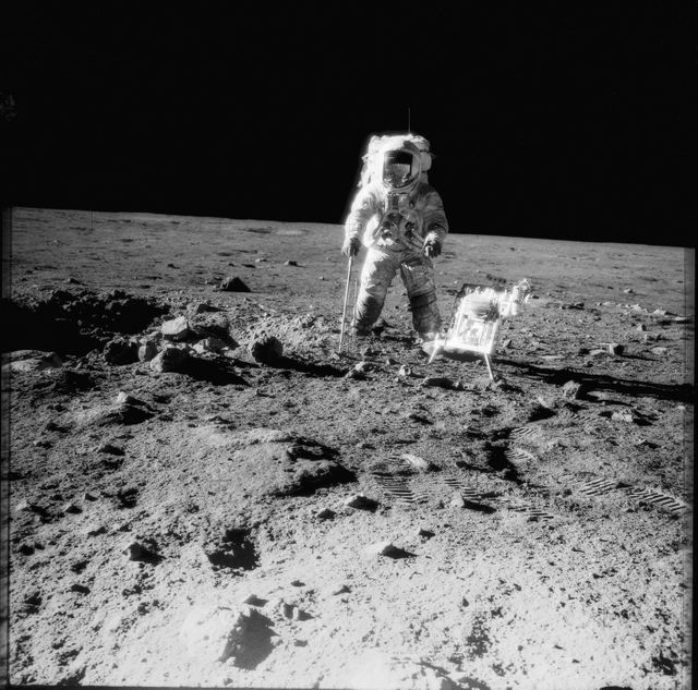 AS12-49-7318 (19-20 Nov. 1969) --- One of the Apollo 12 crew members is photographed with the tools and carrier of the Apollo Lunar Hand Tools (ALHT) during extravehicular activity (EVA) on the surface of the moon. Several footprints made by the two crew members during their EVA are seen in the foreground. While astronauts Charles Conrad Jr., commander, and Alan L. Bean, lunar module pilot, descended in the Lunar Module (LM) "Intrepid" to explore the Ocean of Storms region of the moon, astronaut Richard F. Gordon Jr., command module pilot, remained with the Command and Service Modules (CSM) "Yankee Clipper" in lunar orbit.