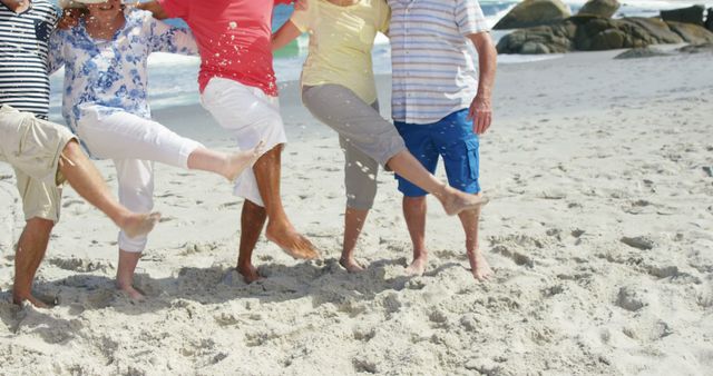 Group of friends playing together on beach, kicking up sand and enjoying sunny day. Could be used for advertisements, travel brochures, lifestyle blogs, tourism promotions, or social media campaigns highlighting summer fun and friendship activities.