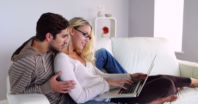 Couple Using Laptop on Sofa in Living Room - Download Free Stock Images Pikwizard.com