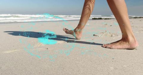 Woman Walking on Sandy Beach with Ocean Waves and Footprints