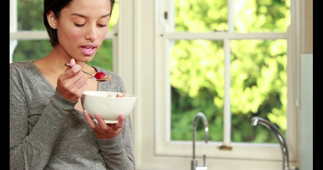 Young Woman Enjoying Breakfast in Bright Kitchen - Download Free Stock Images Pikwizard.com