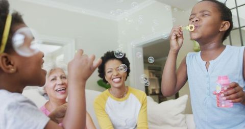 Family enjoying quality time blowing bubbles indoors