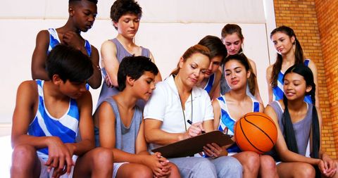 Teen Basketball Team Strategizing with Coach in Gym - Download Free Stock Images Pikwizard.com