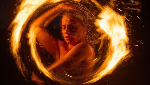Dynamic fire spinner captured in artistic fiery action