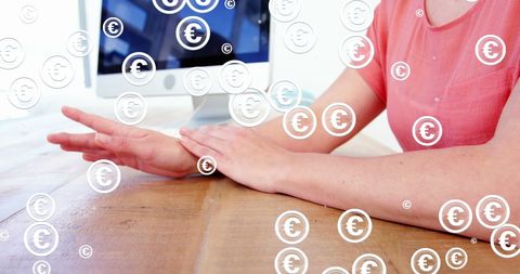 Business Person in Office with Overlaying Euro Symbols