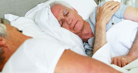 Peaceful Senior Couple Sleeping at Home in Bedroom