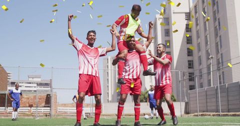 Victorious Football Team Celebrating under Falling Confetti