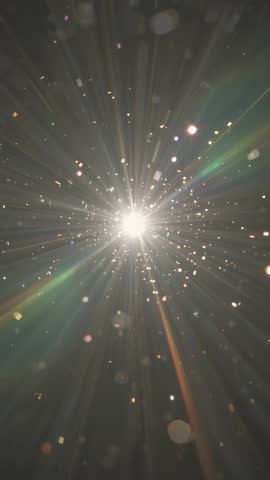 Vertical video bursting golden light rays illuminating floating particles in dark space