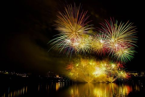 Vibrant fireworks display over waterfront at night